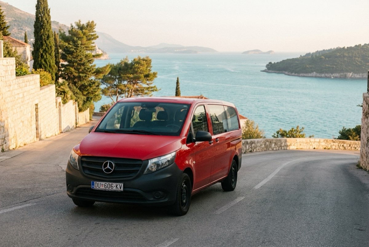 Red Mercedes-Benz Vito on a Dubrovnik coast road above the Adriatic